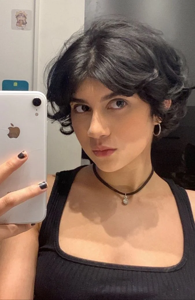 Photo showing wavy bixie bangs, with the hairstyle clearly visible.
