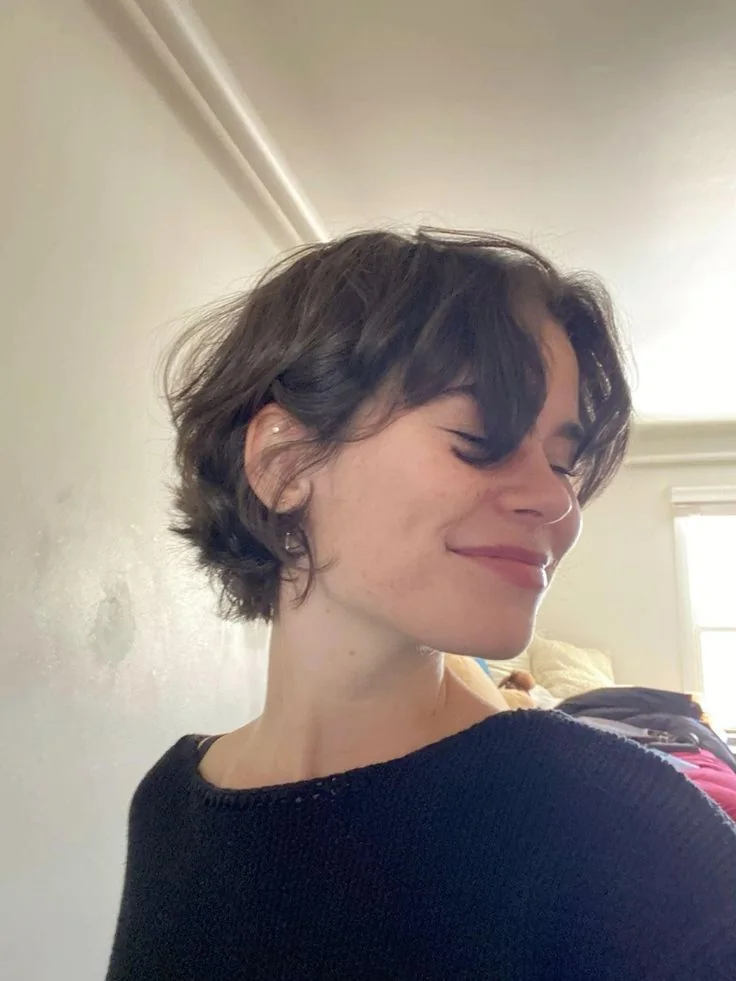 Photo showing wavy bixie curtain bangs, with the hairstyle clearly visible.