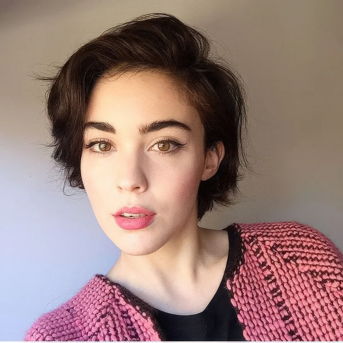 Photo showing dark brown pixie bob, with the hairstyle clearly visible.