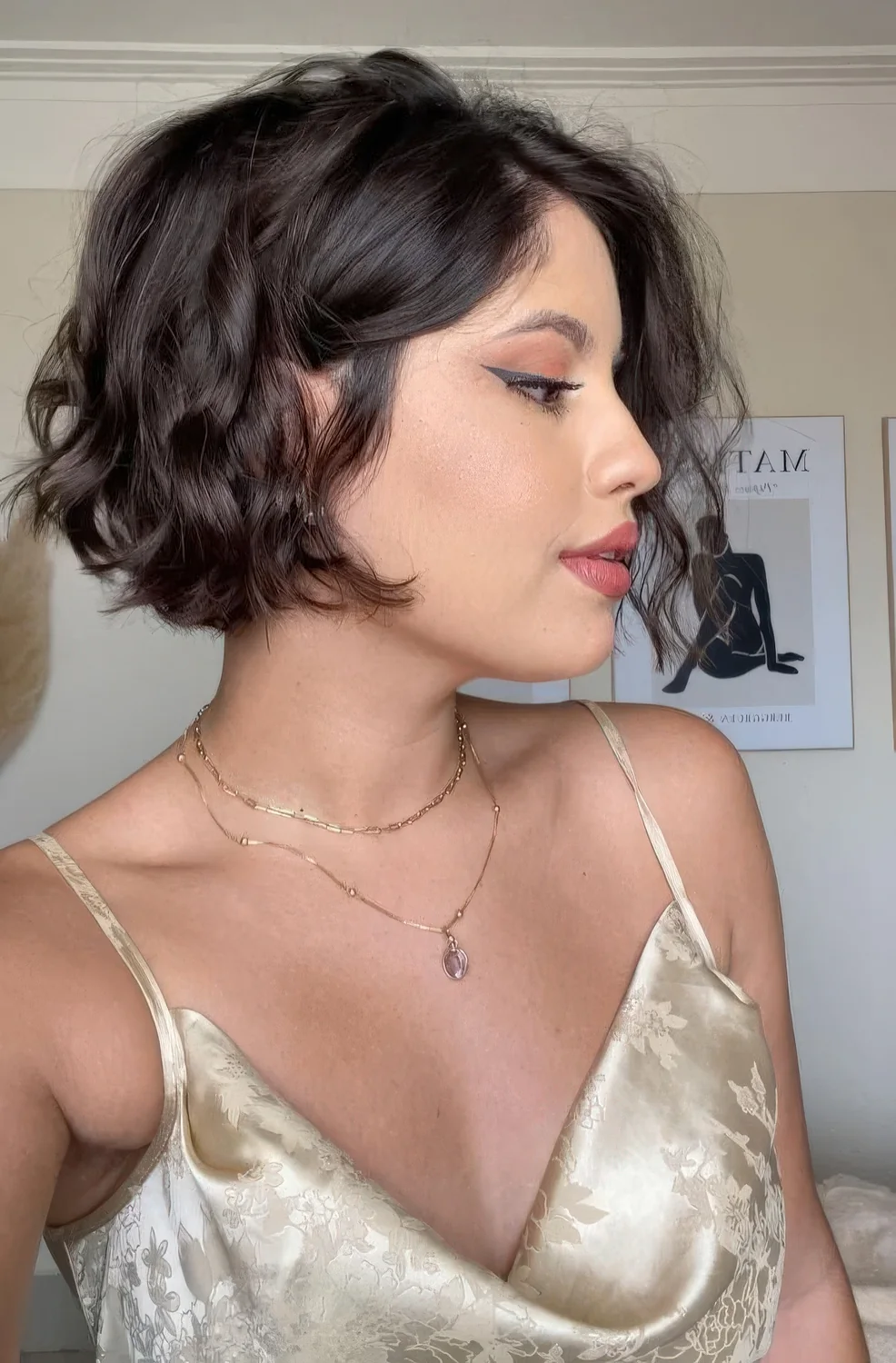 Photo showing dark wavy bob pixie, with the hairstyle clearly visible.
