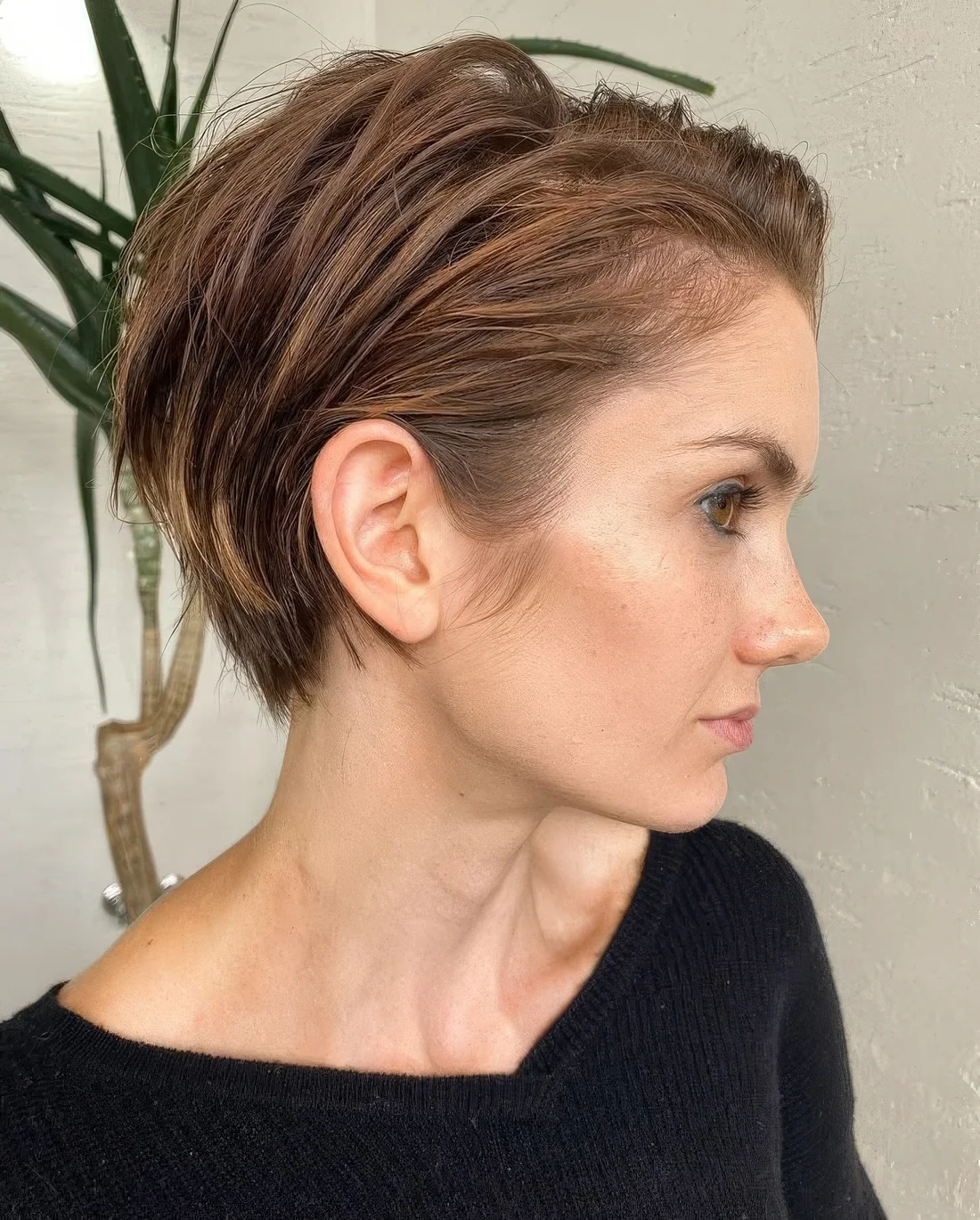 Photo showing light brunette pixie bob, with the hairstyle clearly visible.