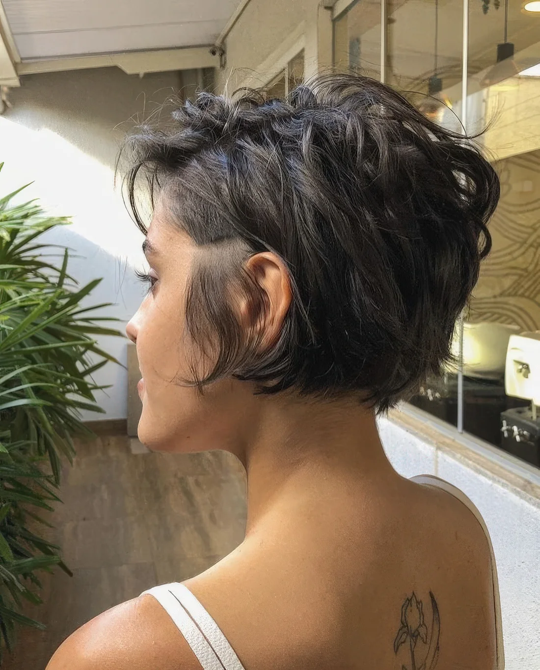Photo showing textural dark pixie bob, with the hairstyle clearly visible.