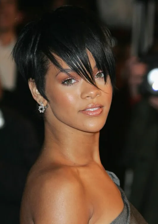 ear straight golden pixie with wispy fringe shown as a pixie with bangs idea, featuring side part
