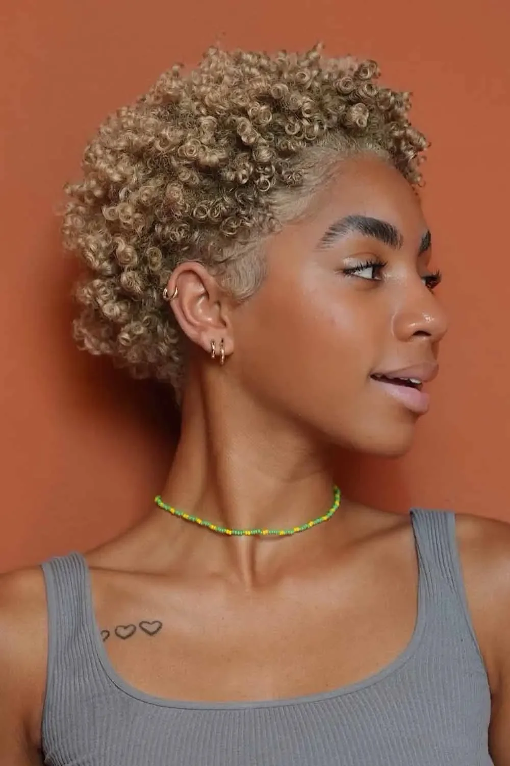 ear curly black curly style with curly fringe fringe shown as a pixie with bangs idea, featuring medium layering