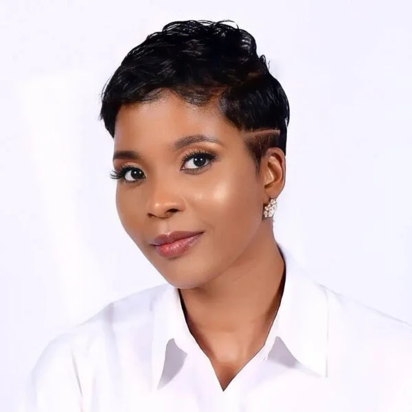 ear coily black pixie with side swept fringe shown as a pixie with bangs idea