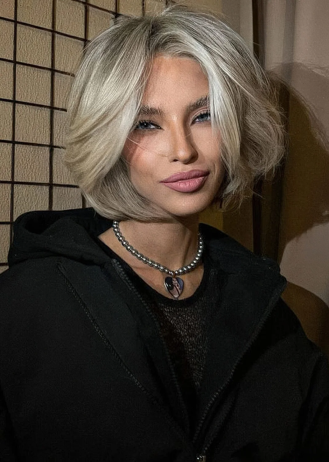 Photo showing cold blonde bob, with the hairstyle clearly visible.