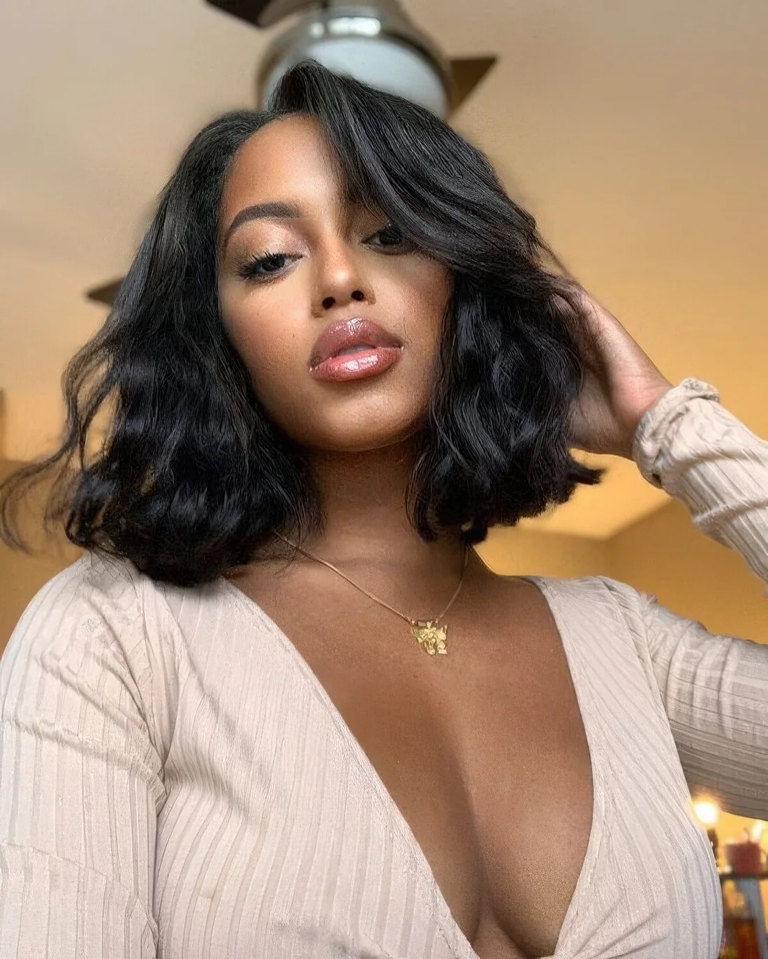 Photo showing wavy plush black bob, with the hairstyle clearly visible.