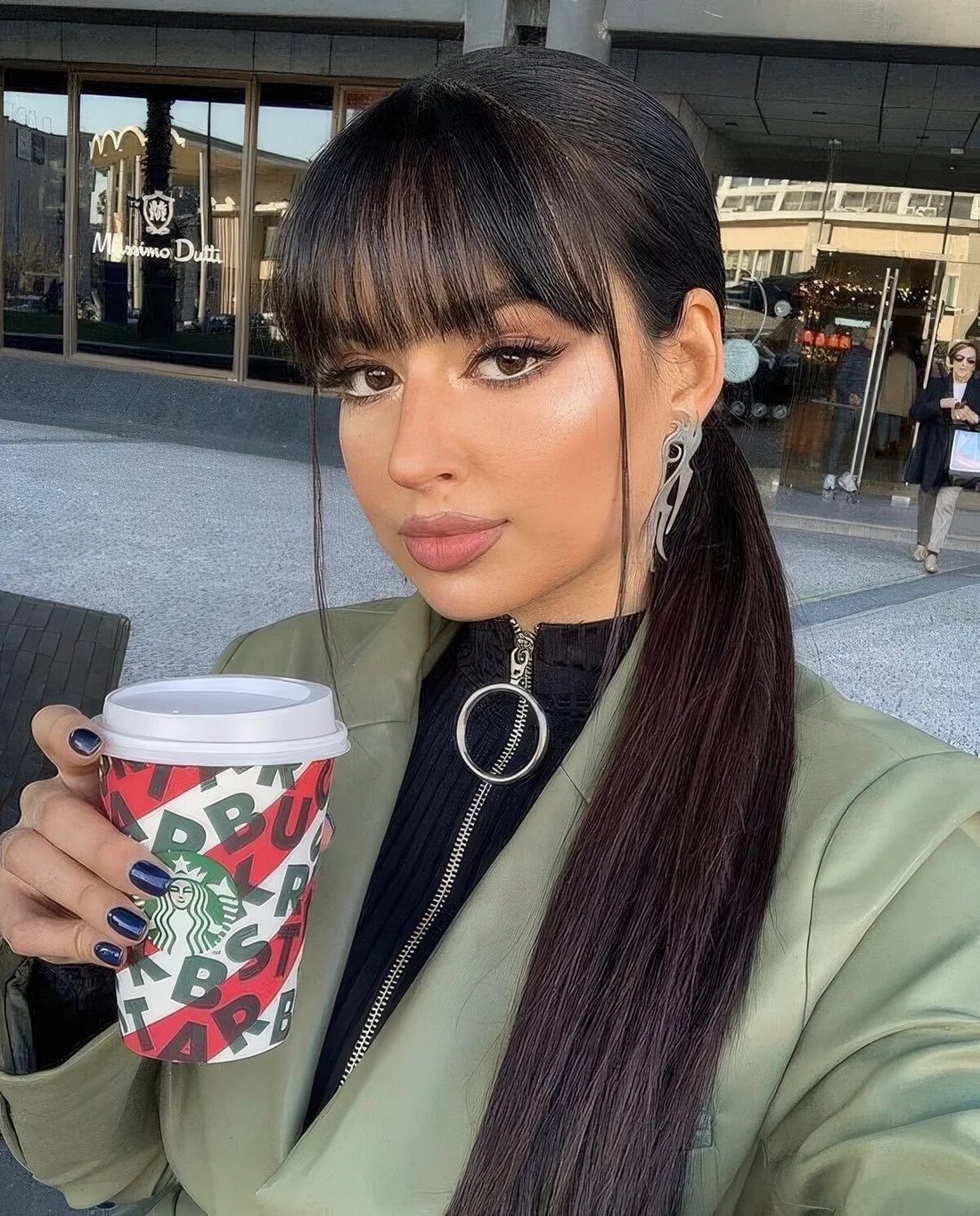 Long straight haircut with a sleek top and long bangs to accent the eyes and frame the face.