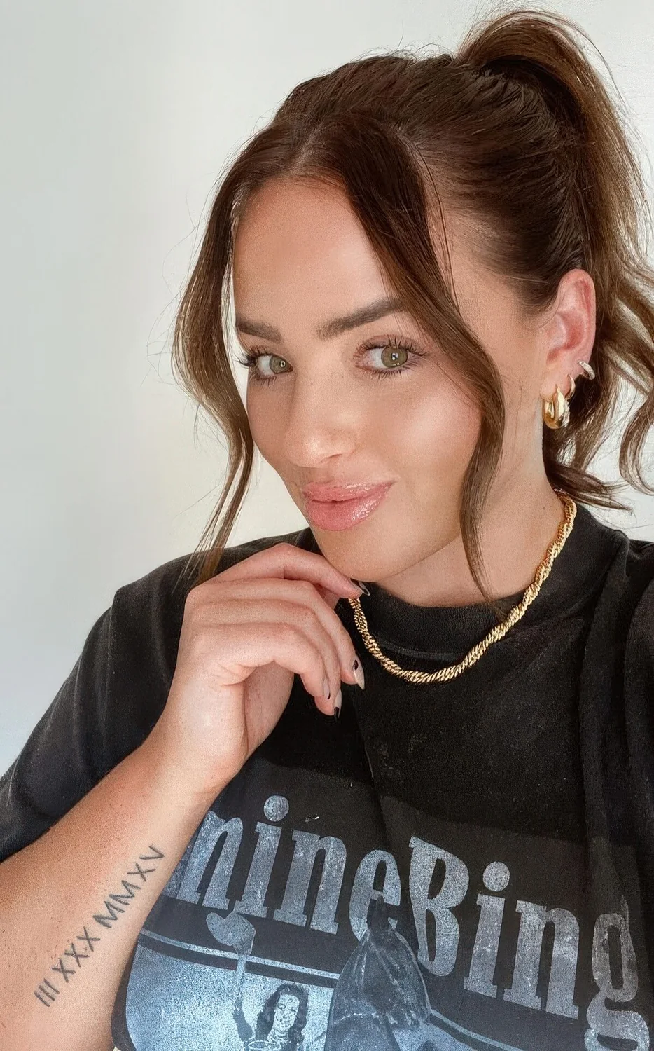 Simple wavy high ponytail on medium hair, with a volume on top and wavy bangs are.