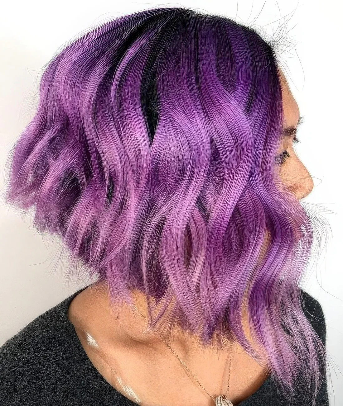 Lavender angled bob with a darker root and waves.