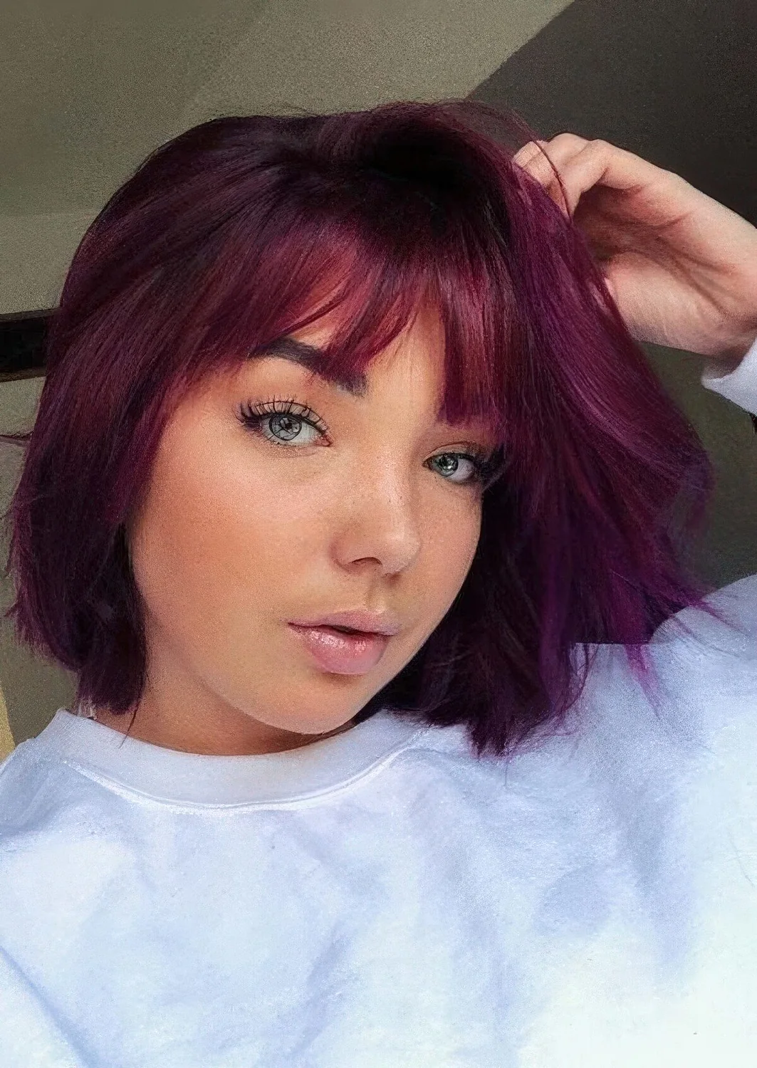 Saturated purple long bob with wispy bangs.