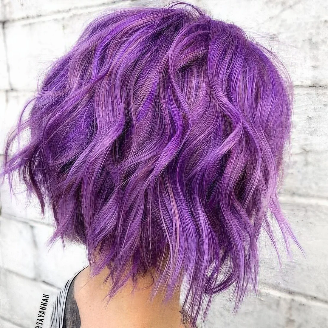 Bright and catchy purple wavy long bob with a lot of volume and texture.