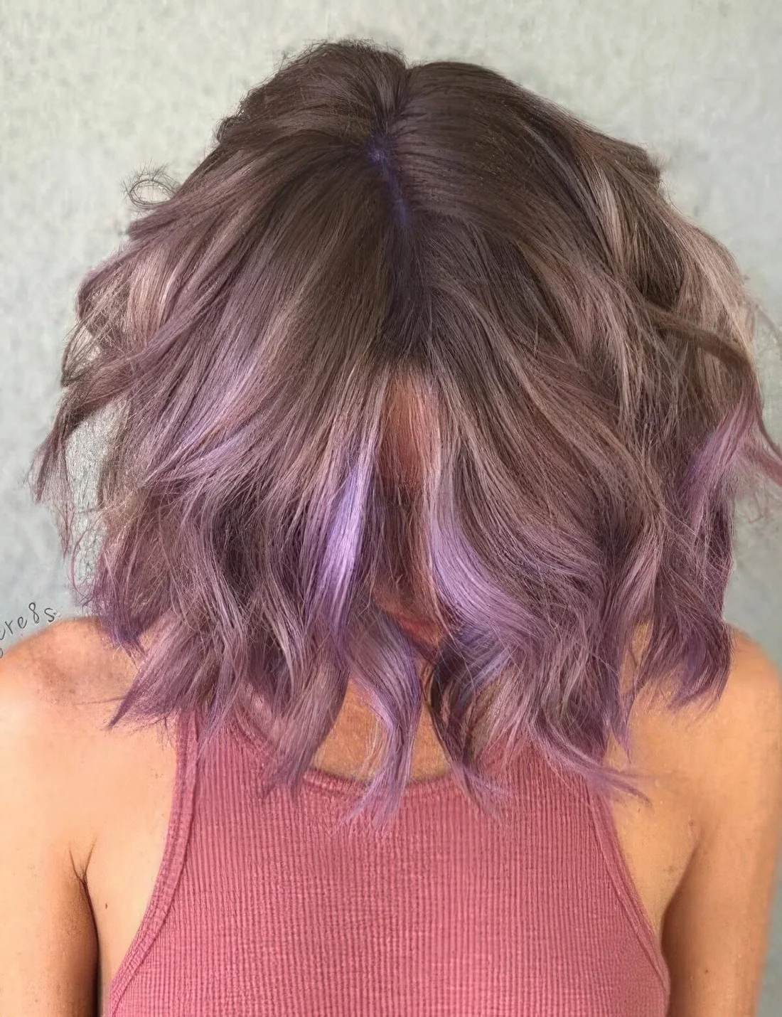 Photo showing lavender wavy long bob, with the hairstyle clearly visible.