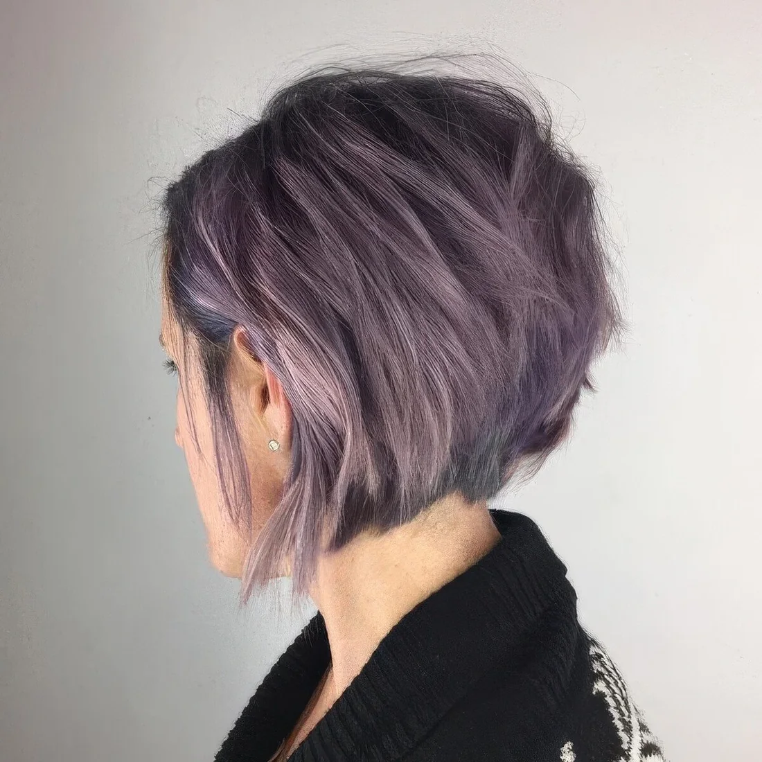 Lavender angled bob with a lot of volume and texture and a darker root.