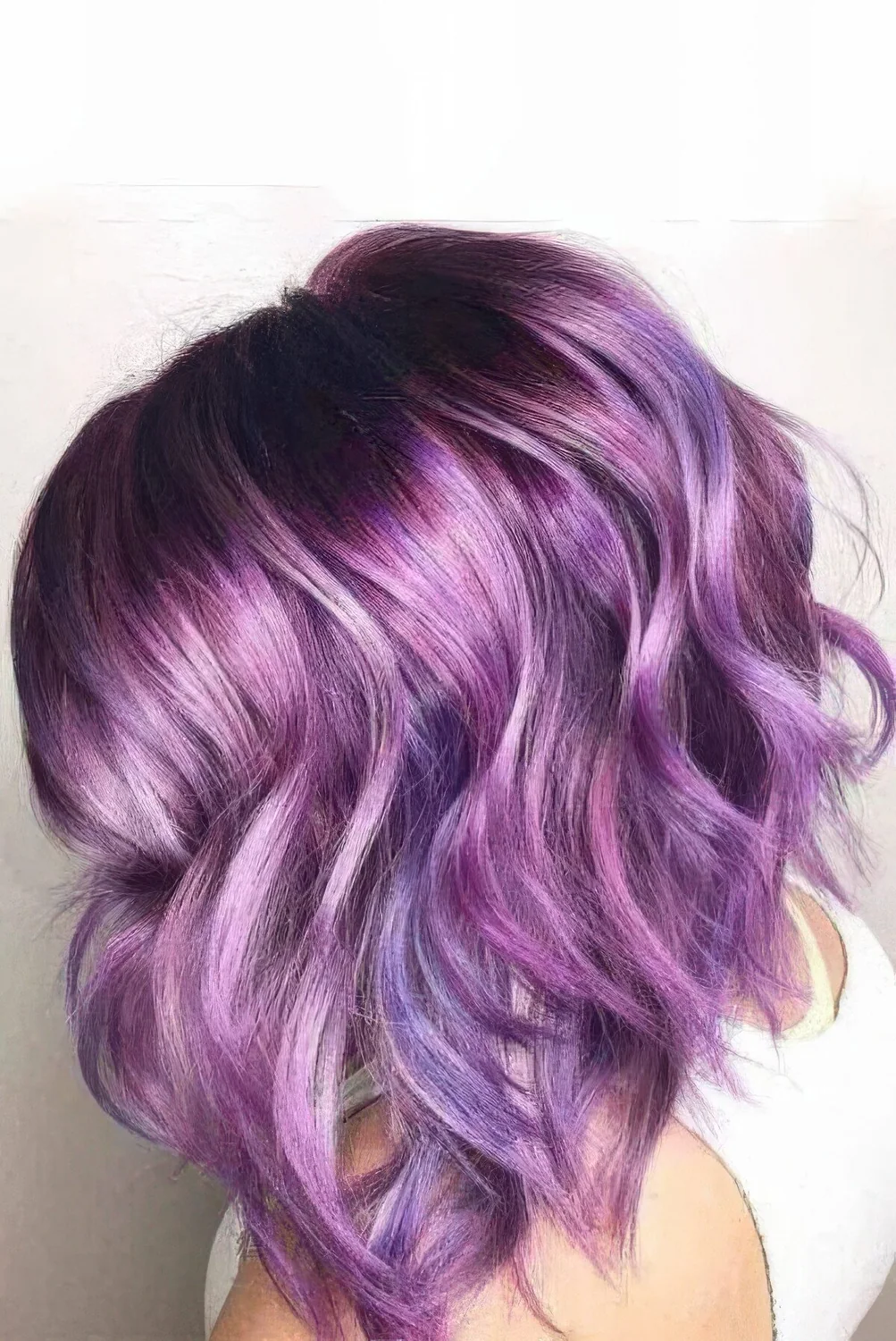 Purple chopped and angled wavy bob with shiny hair.