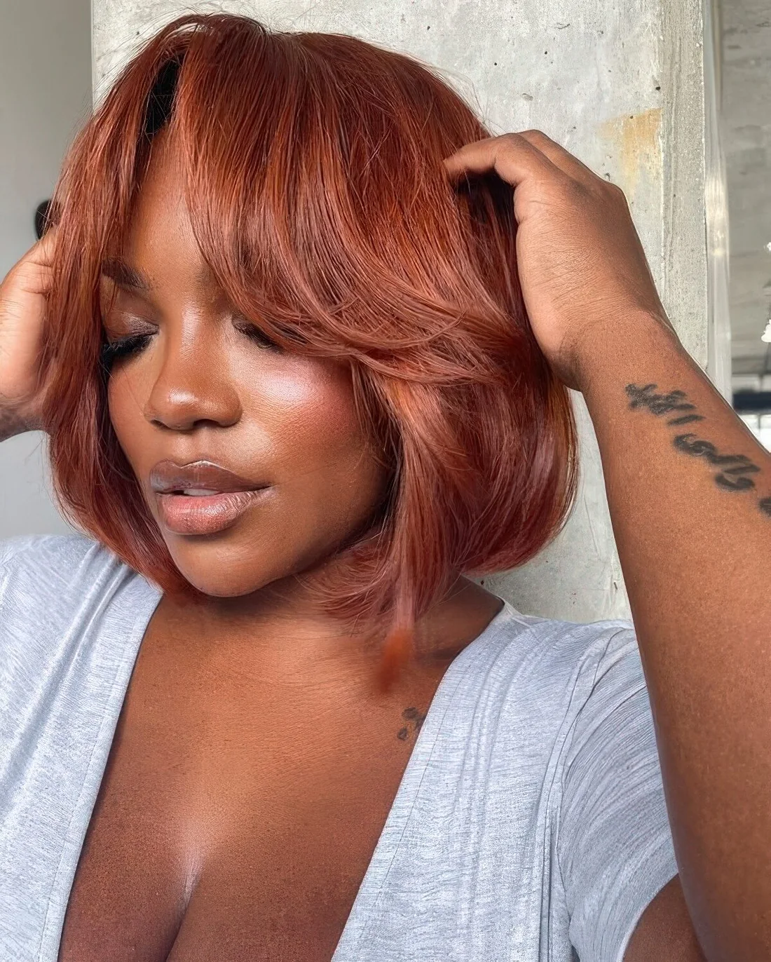 Red long bob with curtain bangs and curved ends.