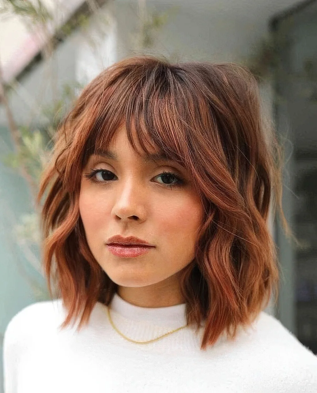 Photo showing shaggy red bob, with the hairstyle clearly visible.