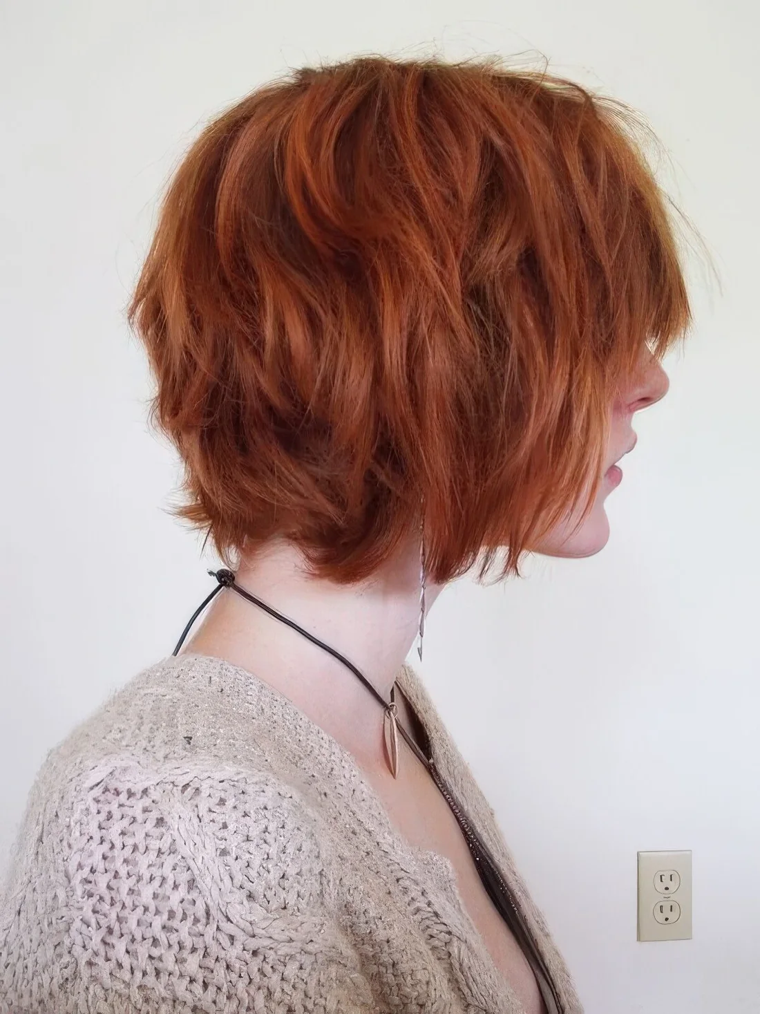 Copper red shaggy chin-length bob with a lot of dimension and texture.