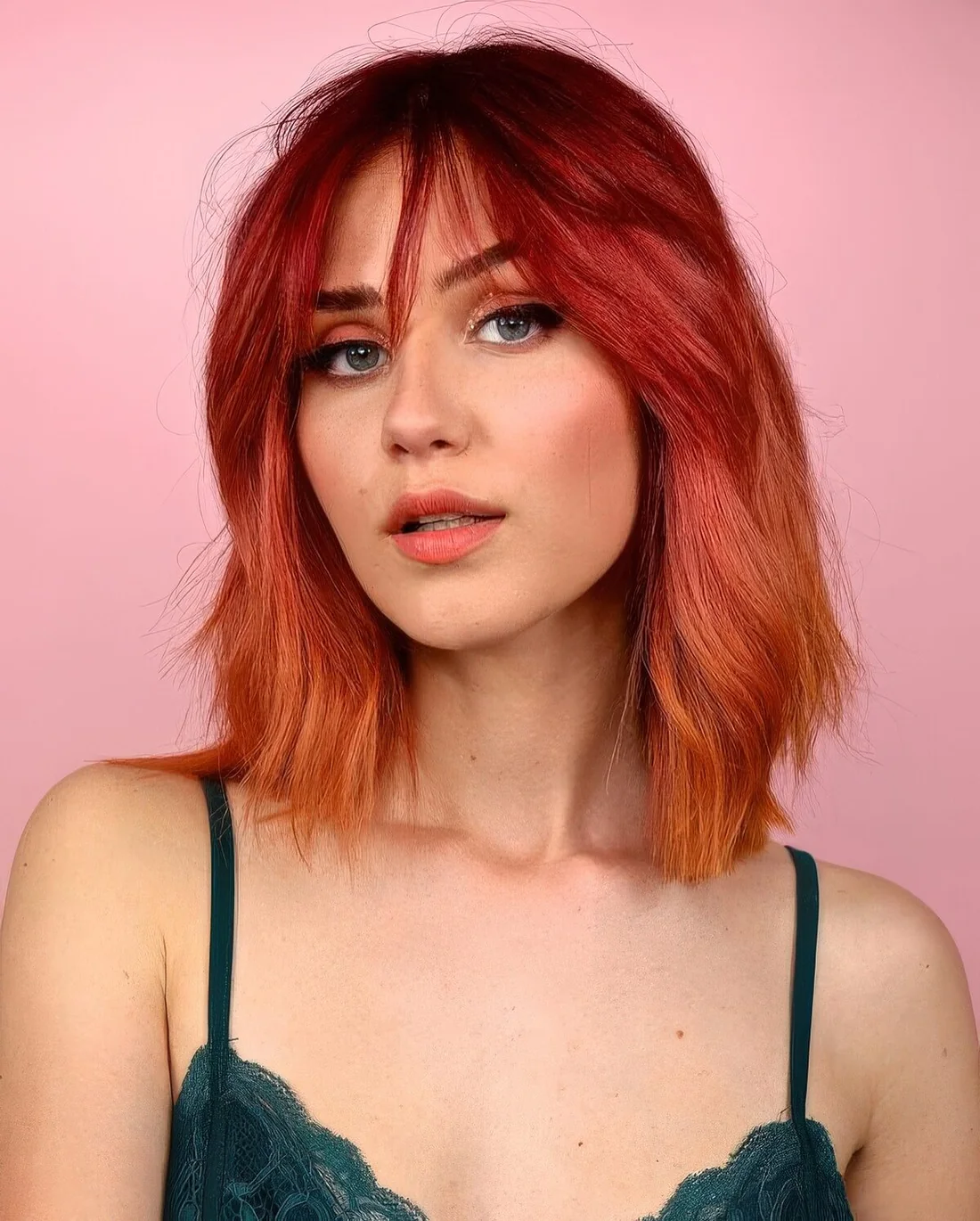 Textural and dimensional red long bob with an ombre effect, from burgundy to hot red and copper red.
