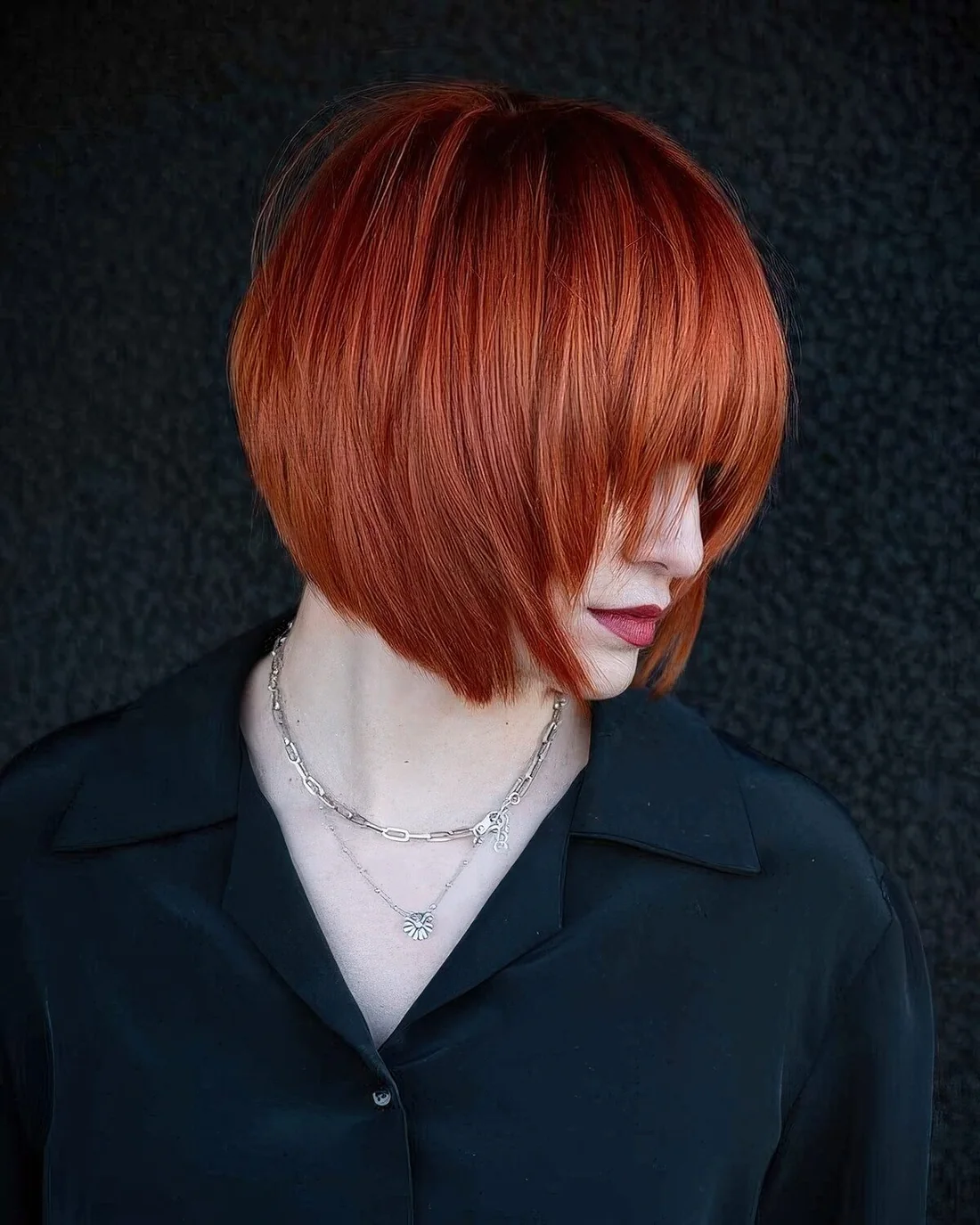 Photo showing red short bob, with the hairstyle clearly visible.