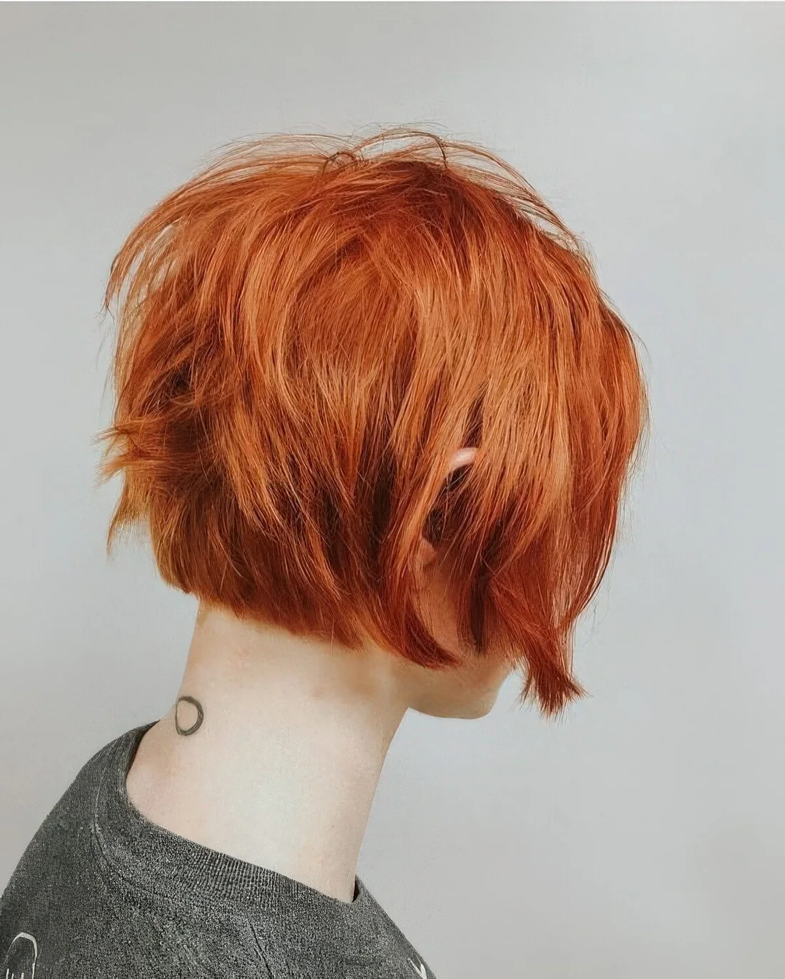 Ear-length copper red bob with a lot of volume and some texture.