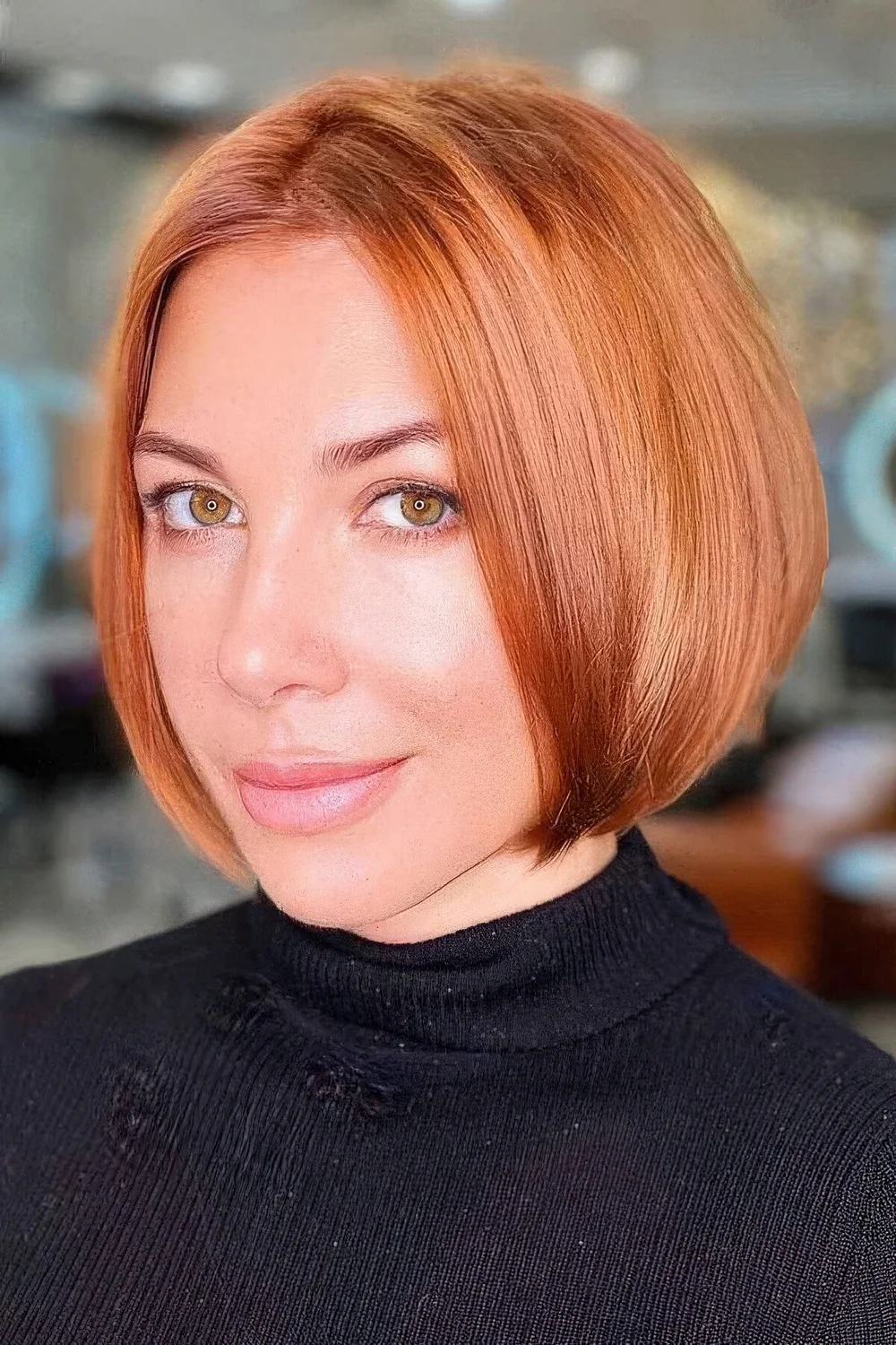 Sleek copper red jaw-length bob with a darker root and a bit of volume.
