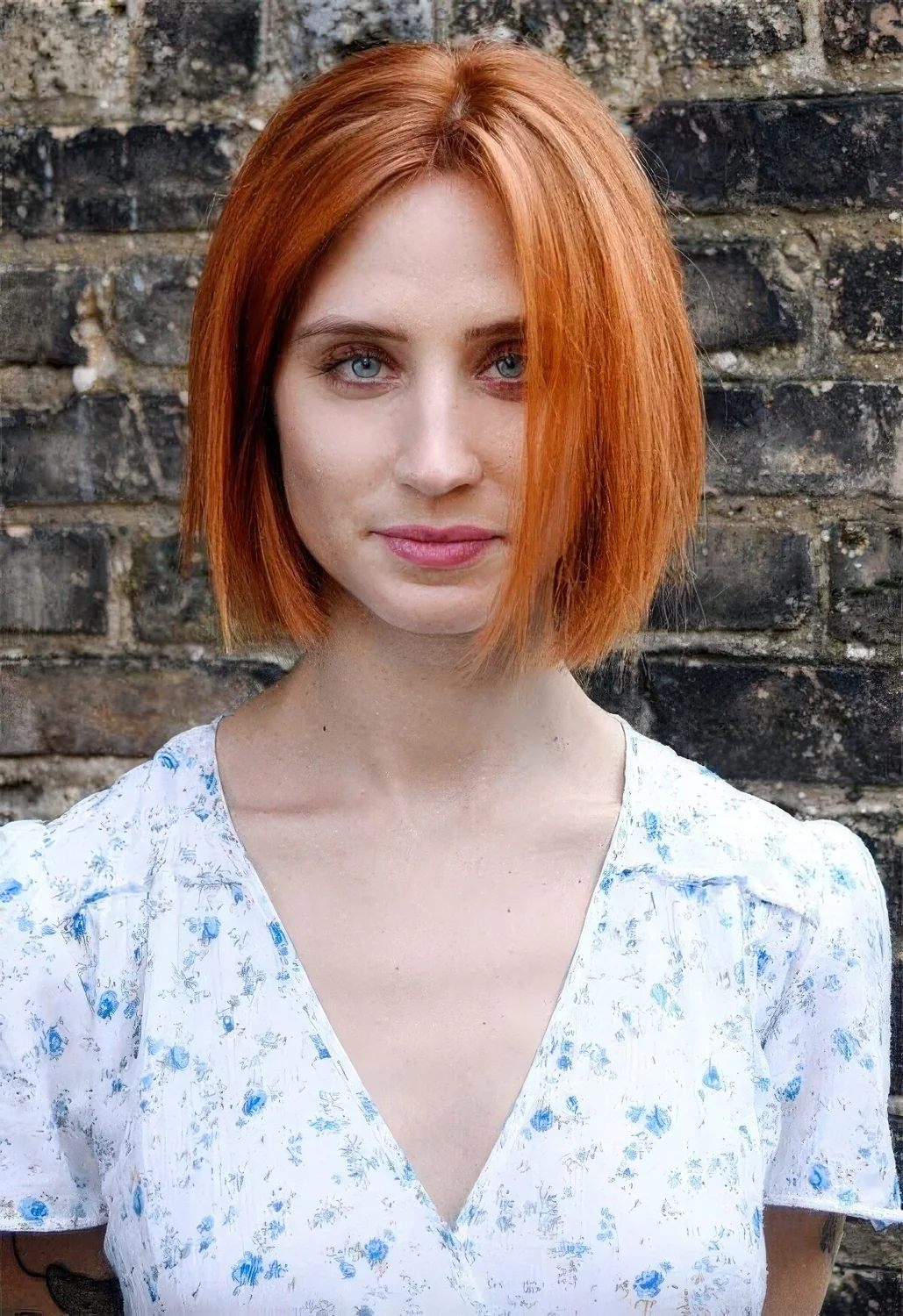 Copper red midi bob with volume and a sleek texture.