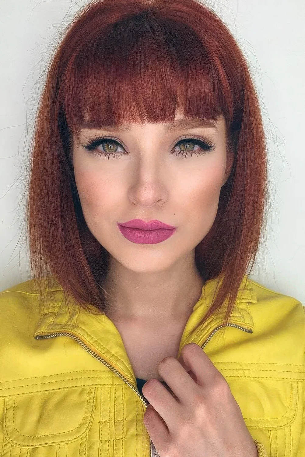 Deep red long bob with a classic fringe and some volume.