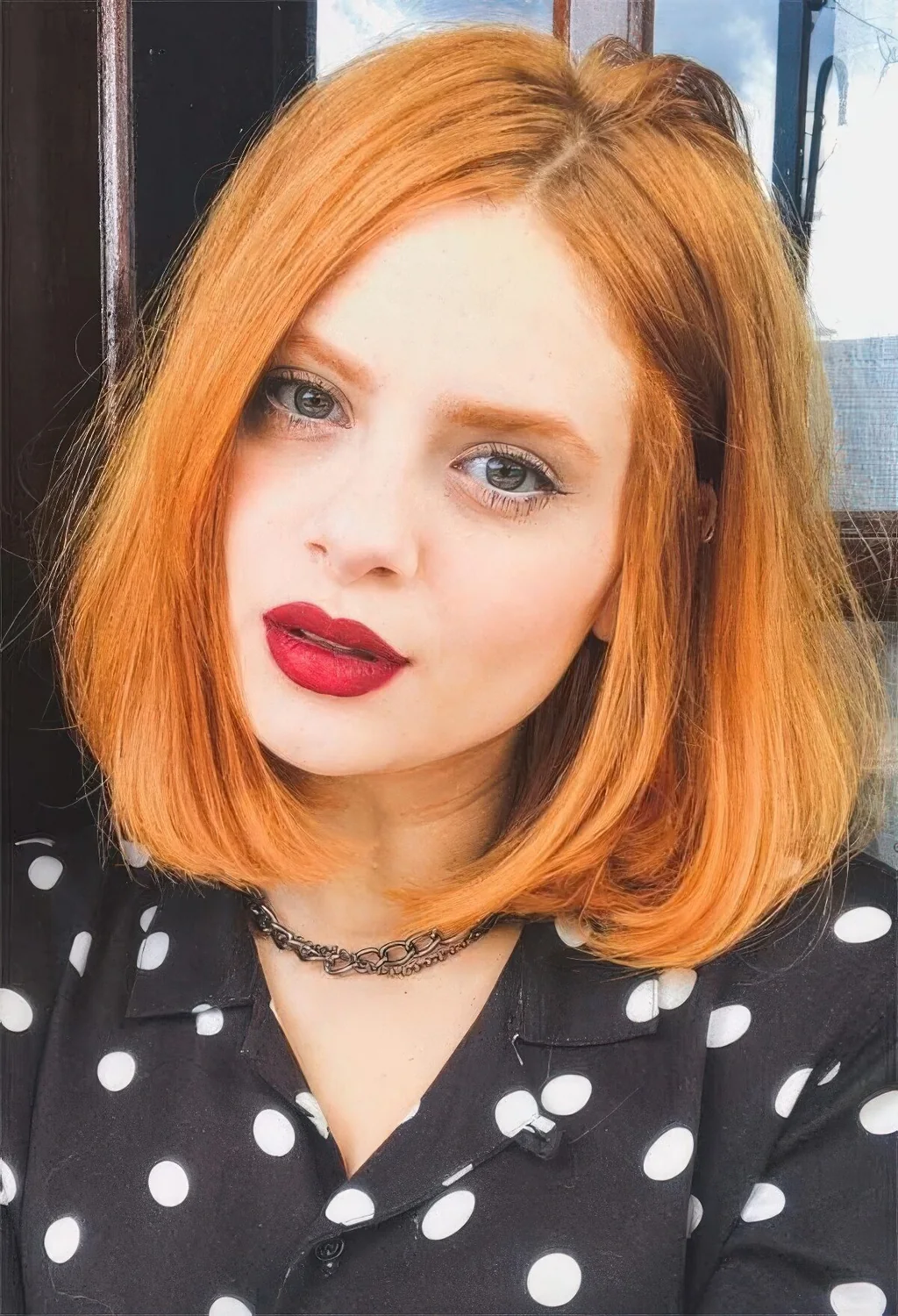Long ginger red bob with a lot of volume and curved ends.