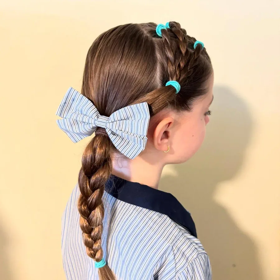 Side braid hairstyle with tiny elastics holding the front layers