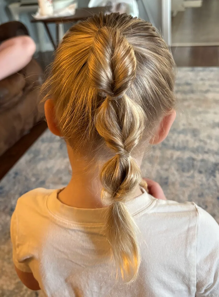Loose Dutch braid down the back for a comfortable school hairstyle