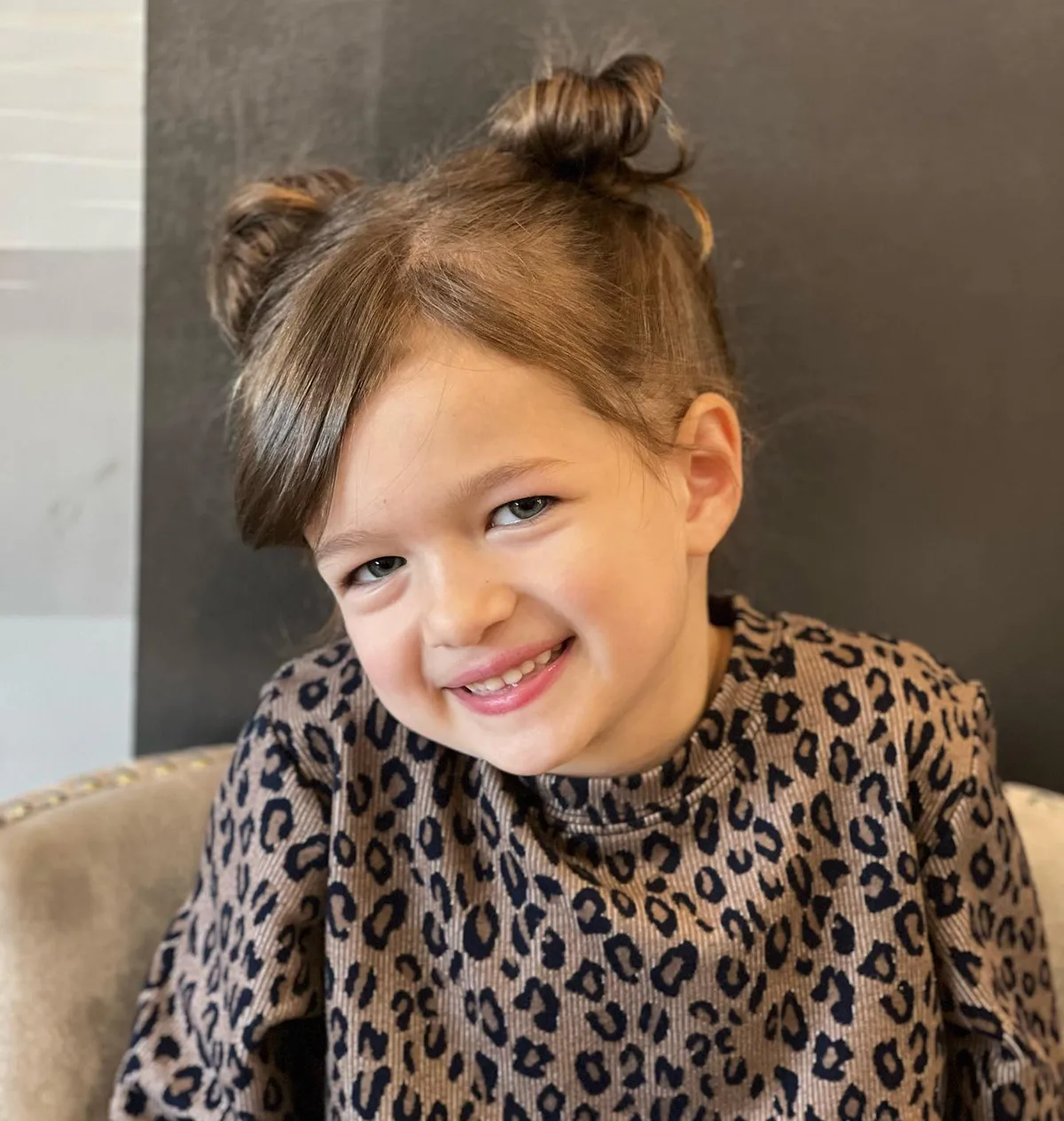 shoulder straight brunette bun shown as a school hairstyles idea, featuring straight texture