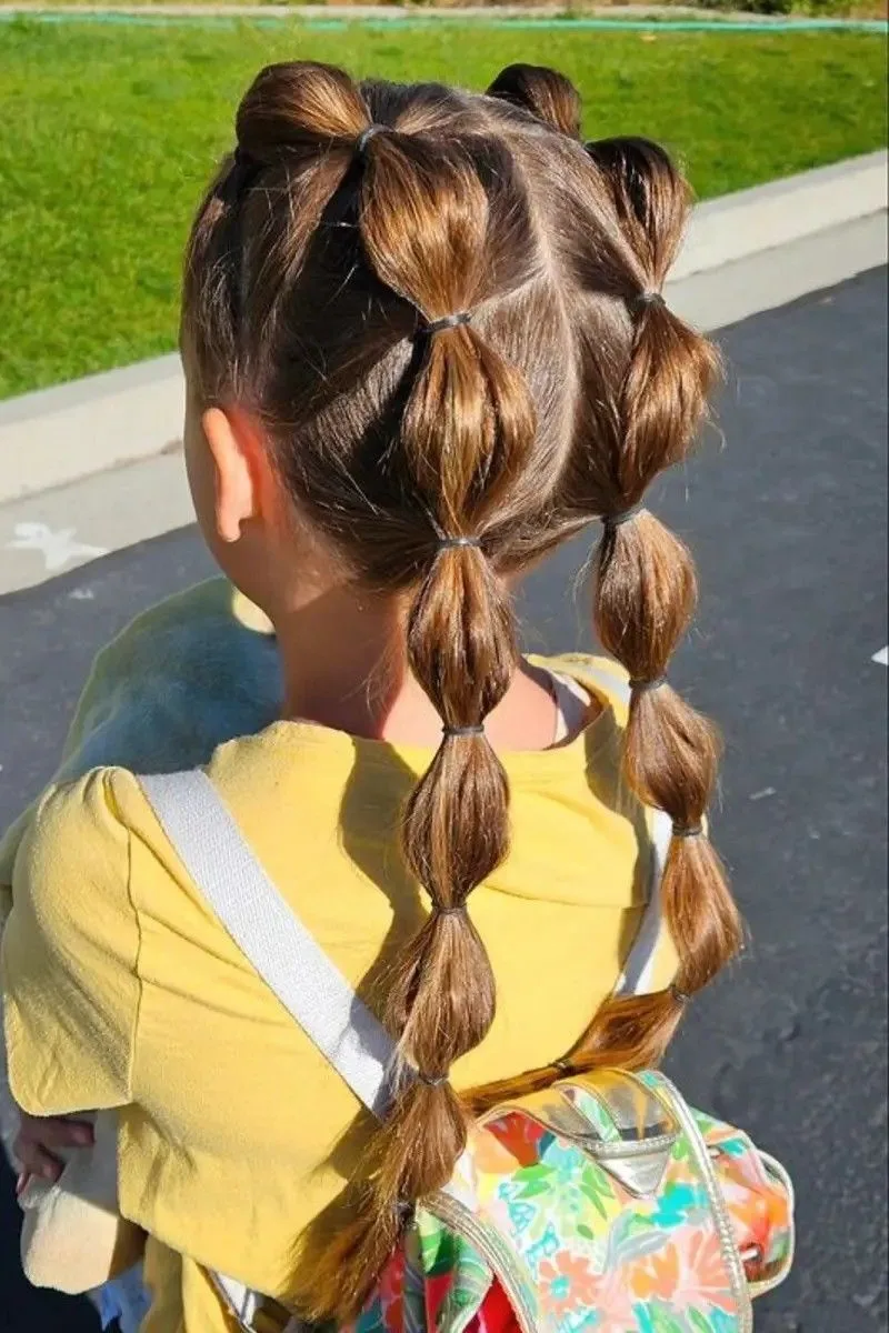 Double braids on long hair that sit comfortably with a backpack