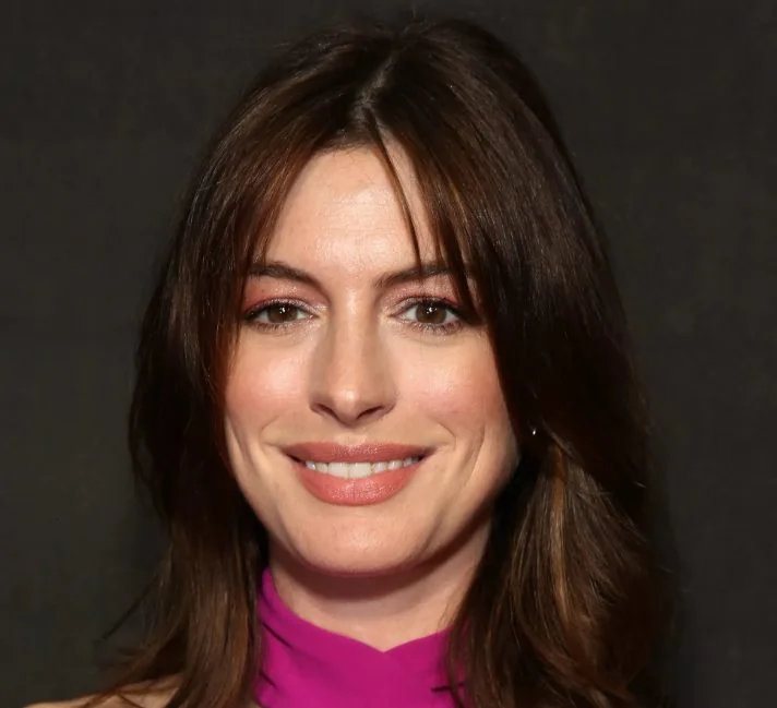 Anne Hathaway's take on the subtle shag has face-framing frontal layers that almost qualify as bangs.