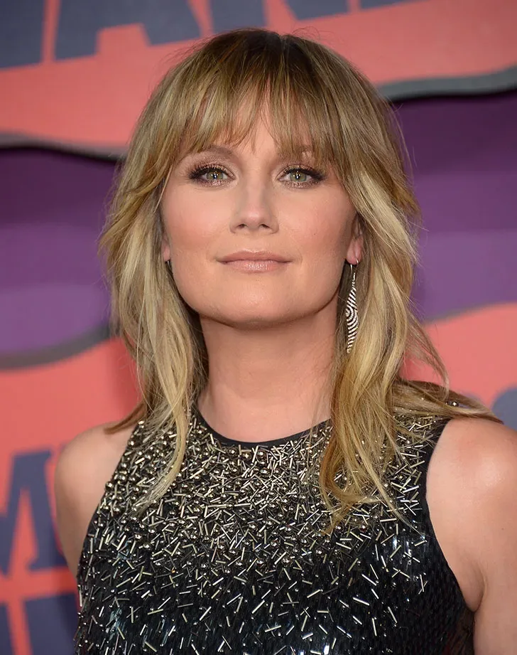 shoulder wavy chestnut shag with curtain fringe shown as a shag hairstyles for medium length thin fine hair idea, featuring wavy texture, shown in soft blonde shag with full airy fringe