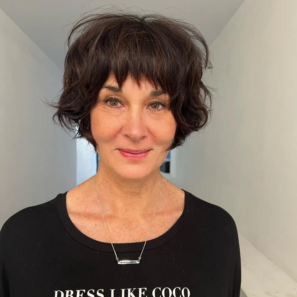 neck wavy brunette shag with wispy fringe shown as a shaggy bob for older women idea
