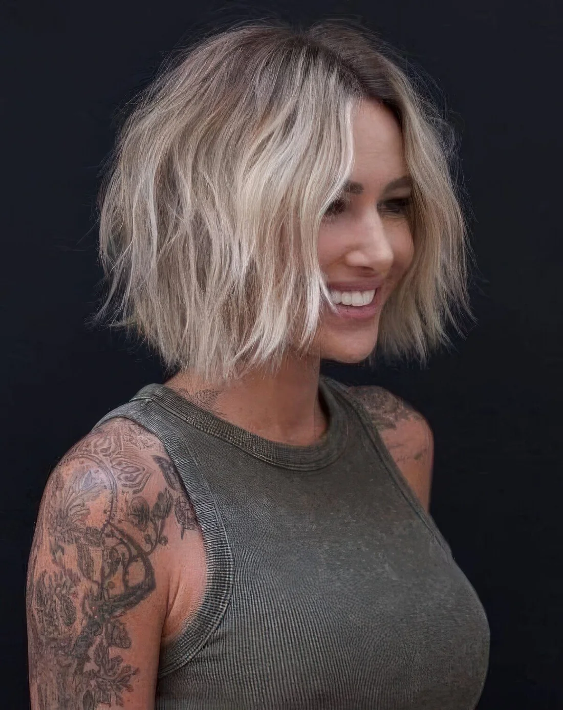 Blonde shaggy short bob with a darker root.
