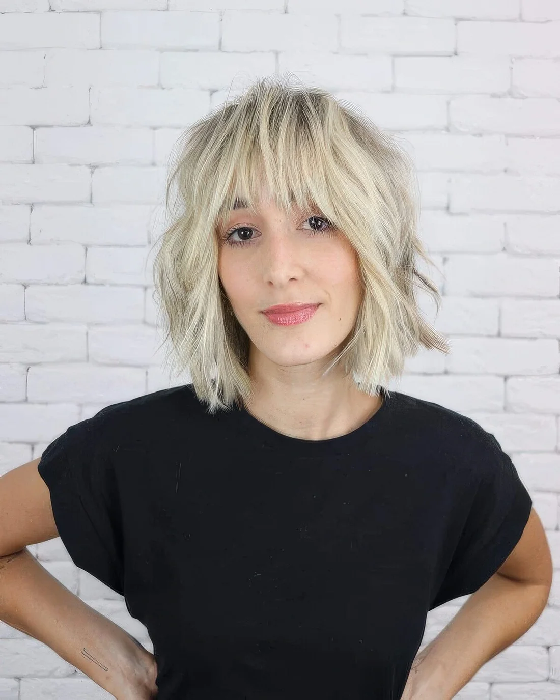 Cold blonde shaggy medium bob with a fringe and cool and lovely texture.