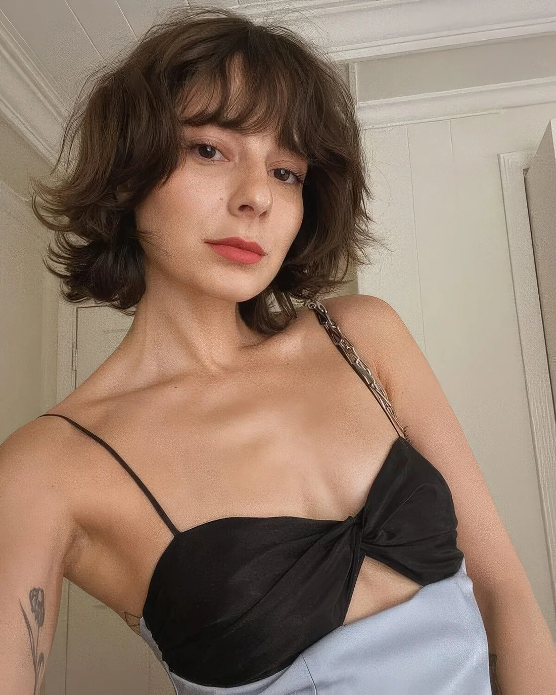 Brunette shaggy bob wih a fringe and messy waves and texture.