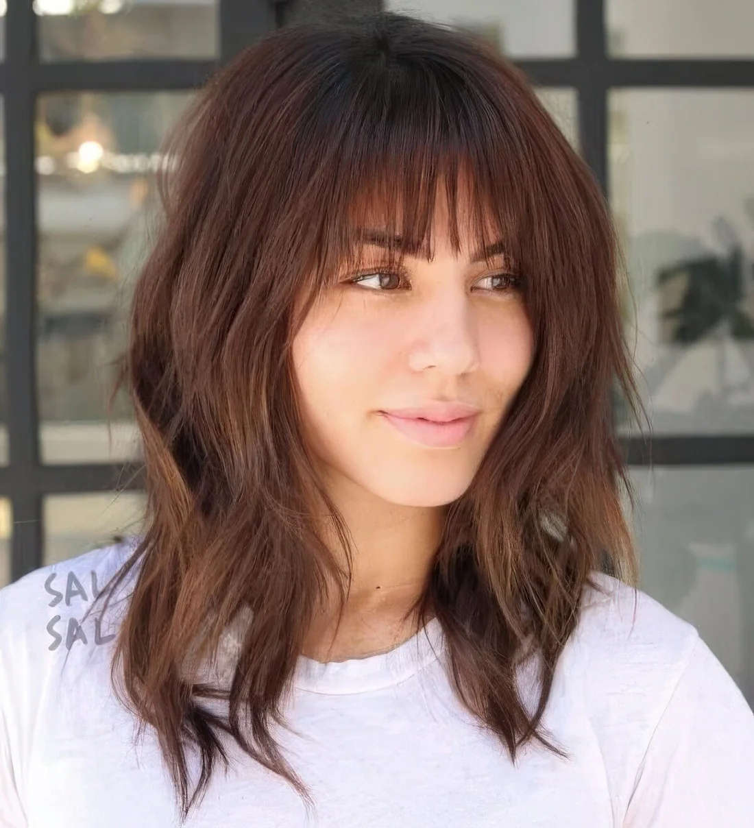 Photo showing long shaggy bob with bangs, with the hairstyle clearly visible.