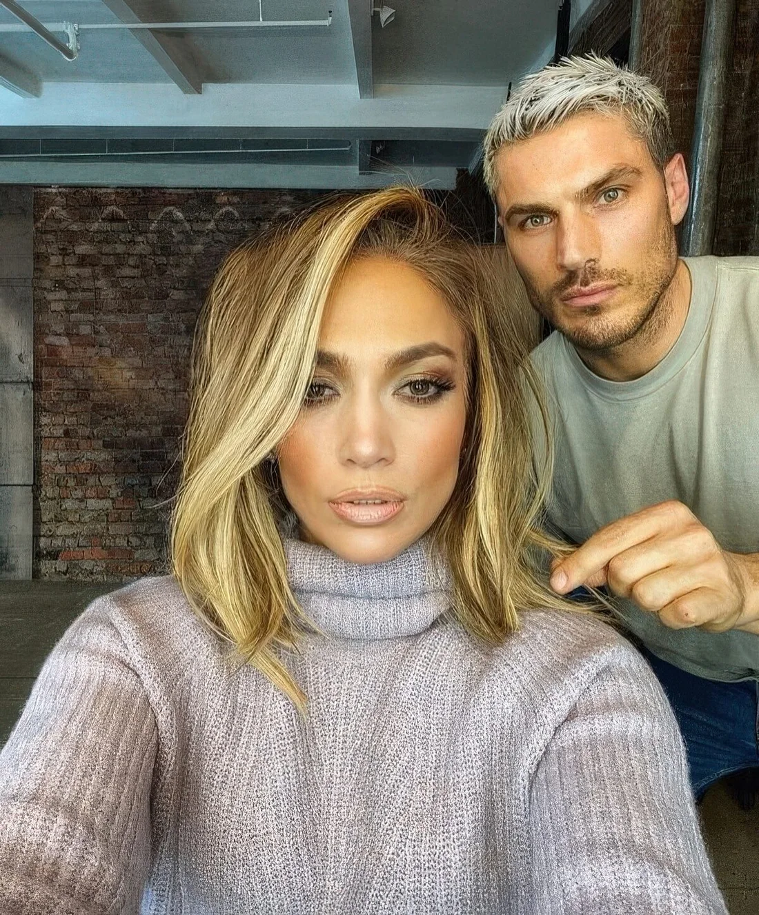 Long shaggy bob with blonde balayage and a long side fringe by J.Lo.