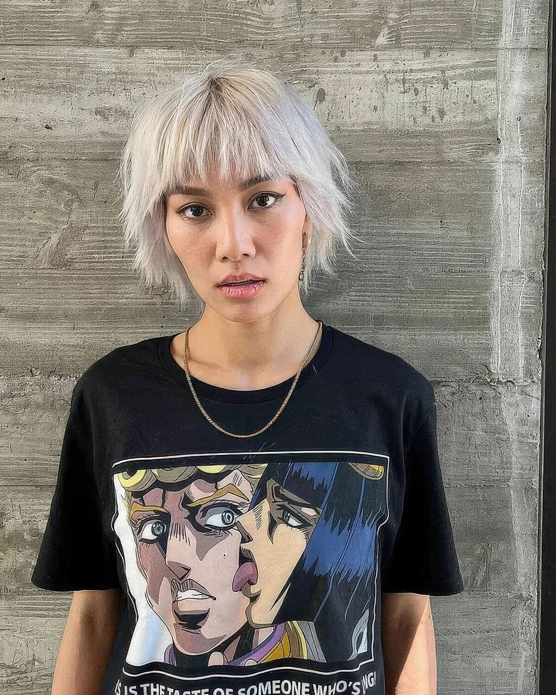 Icy blonde shaggy short bob with a fringe and a lot of texture.