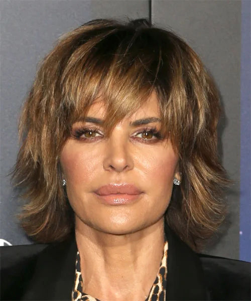 short wavy caramel shag with wispy fringe shown as a shaggy hairstyles for women over 50 idea