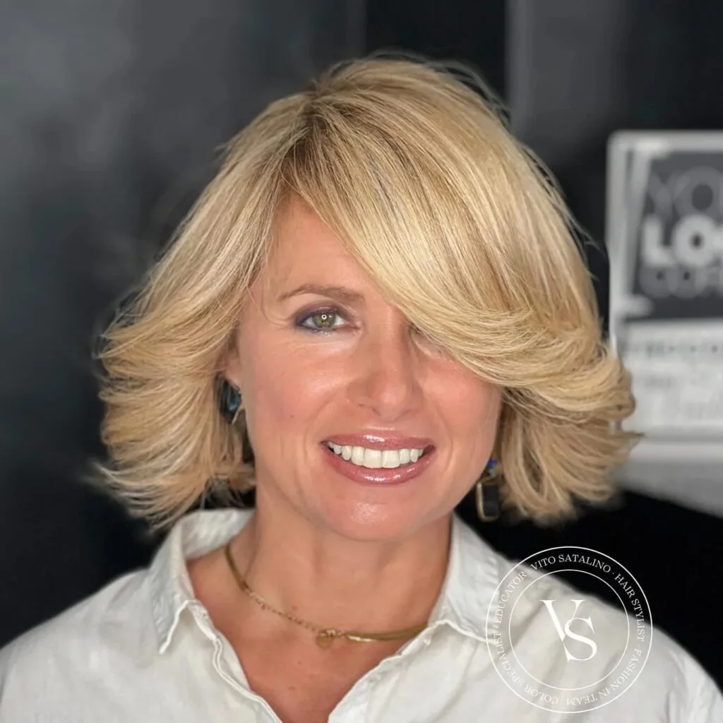 shoulder wavy silver shag with curtain fringe shown as a shaggy hairstyles for women over 50 idea, featuring textured finish