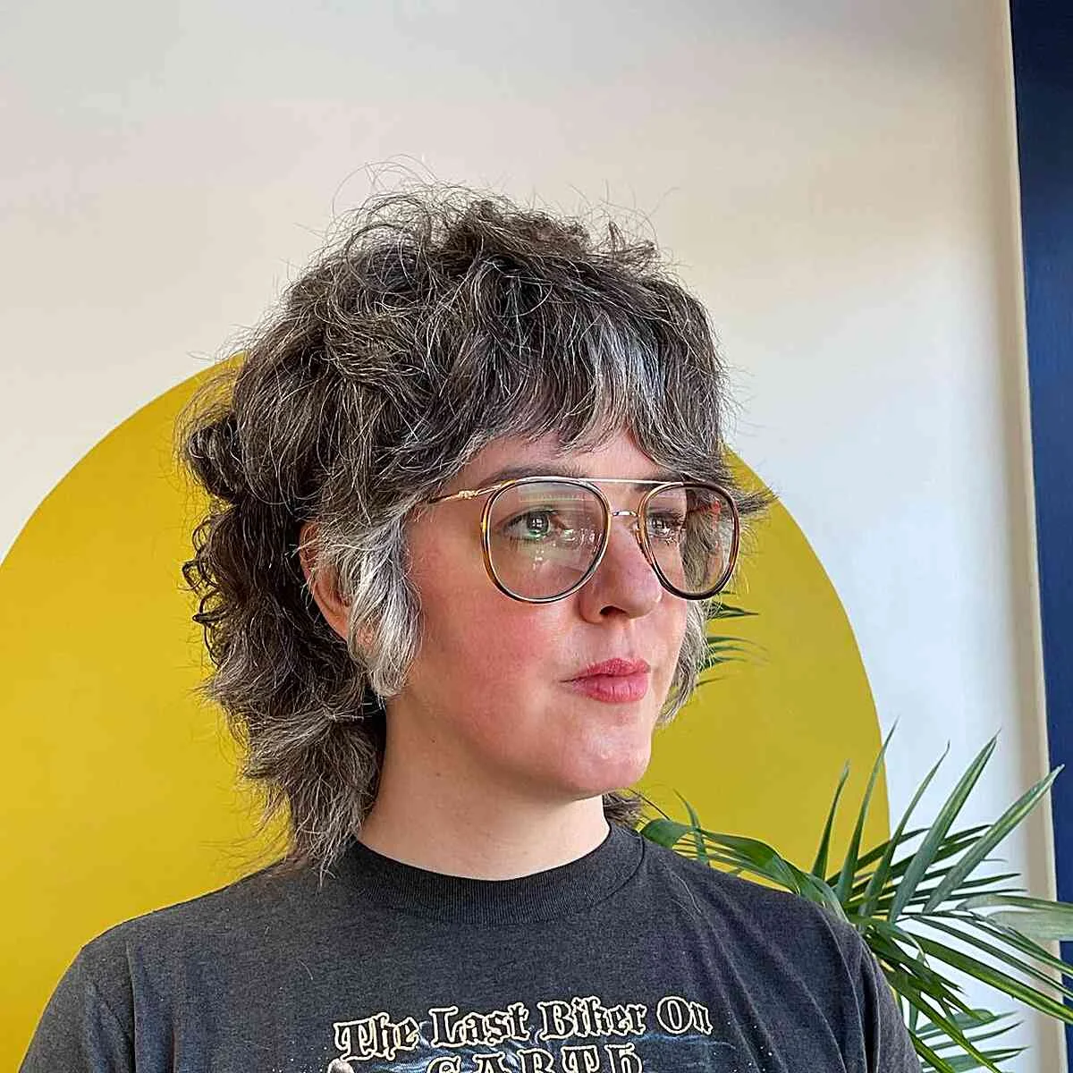 shoulder wavy silver shag with curtain fringe shown as a shaggy hairstyles for women over 50 idea, featuring wavy texture