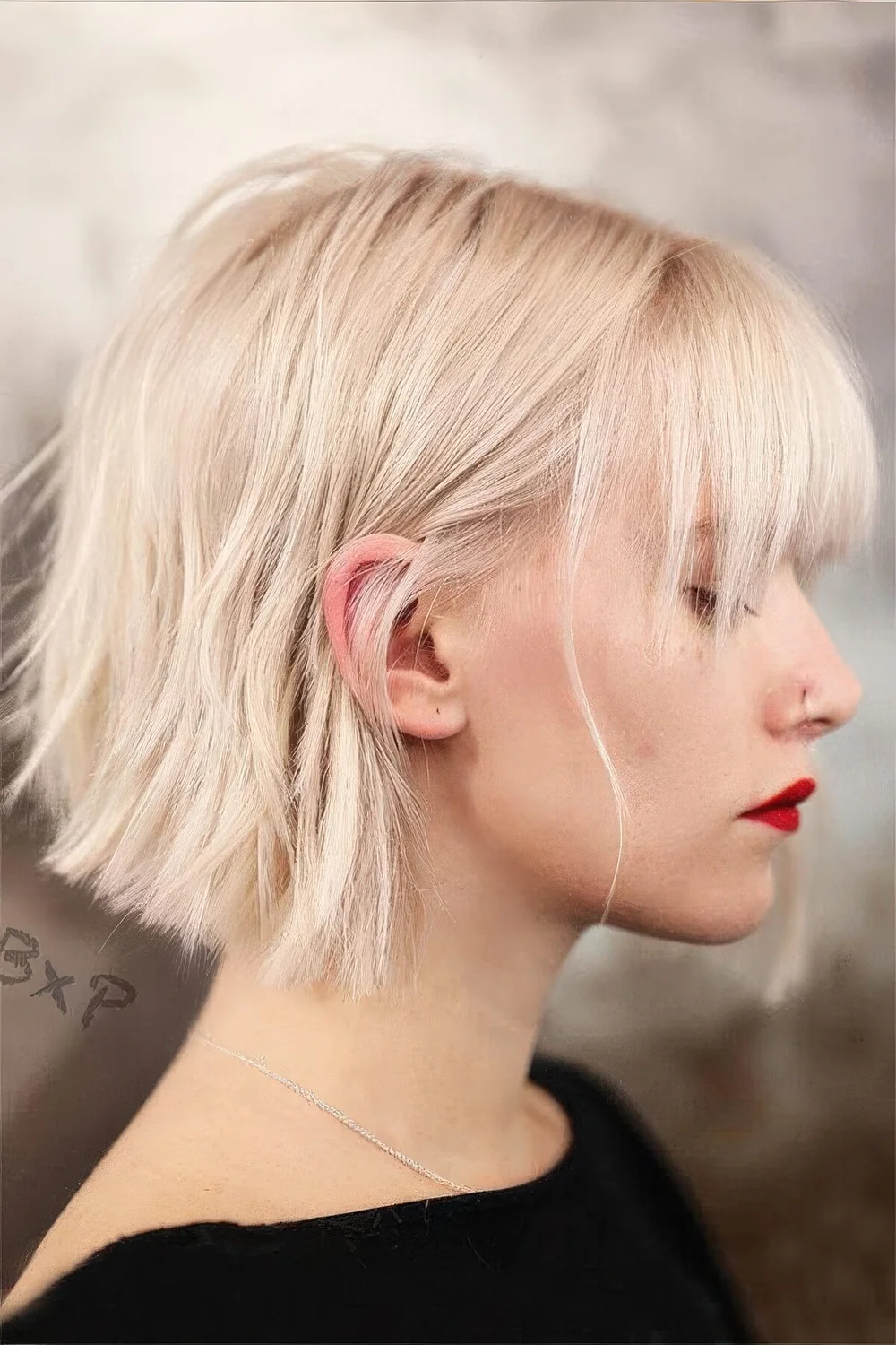 Midi platinum bob with a classic fringe and a lot of volume.