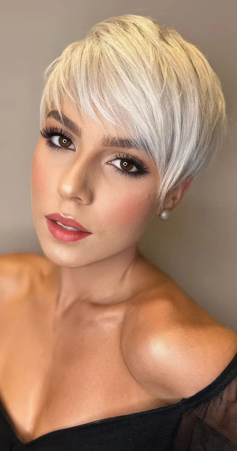 Platinum blonde long pixie with side bangs.
