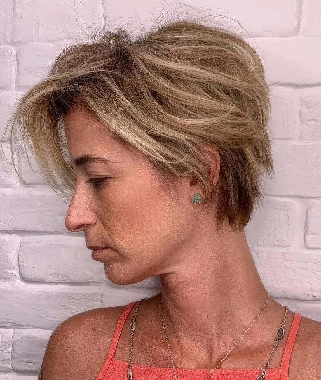 Messy and textural blonde bixie with a messy volume on top.