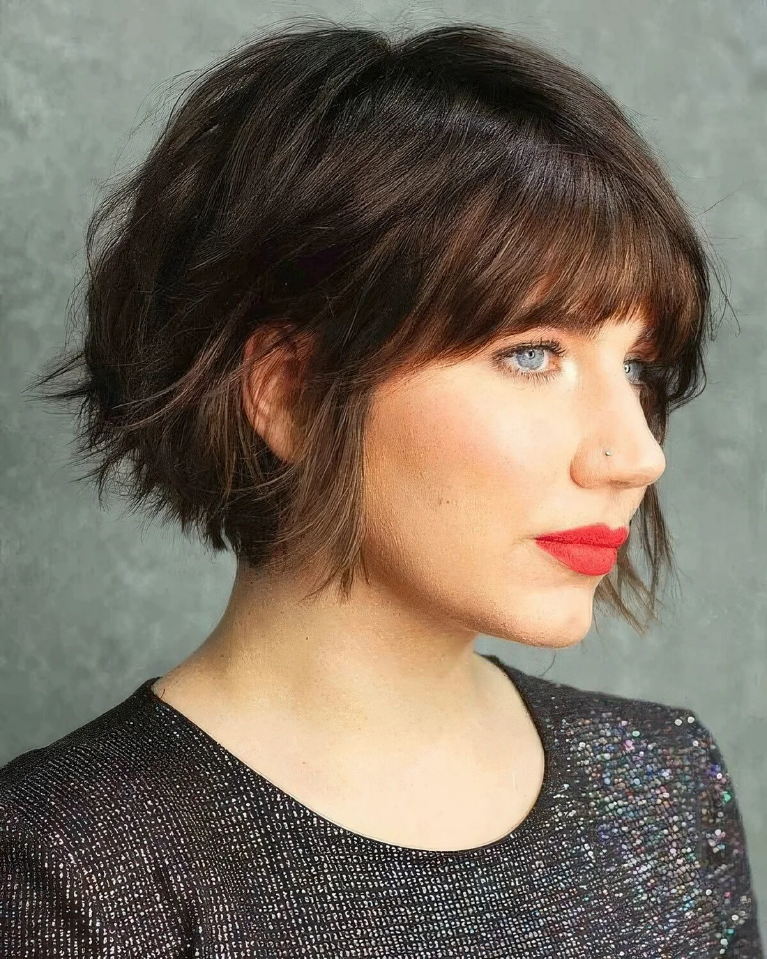 Black jaw-length bob with a shaggy texture and a classic fringe.