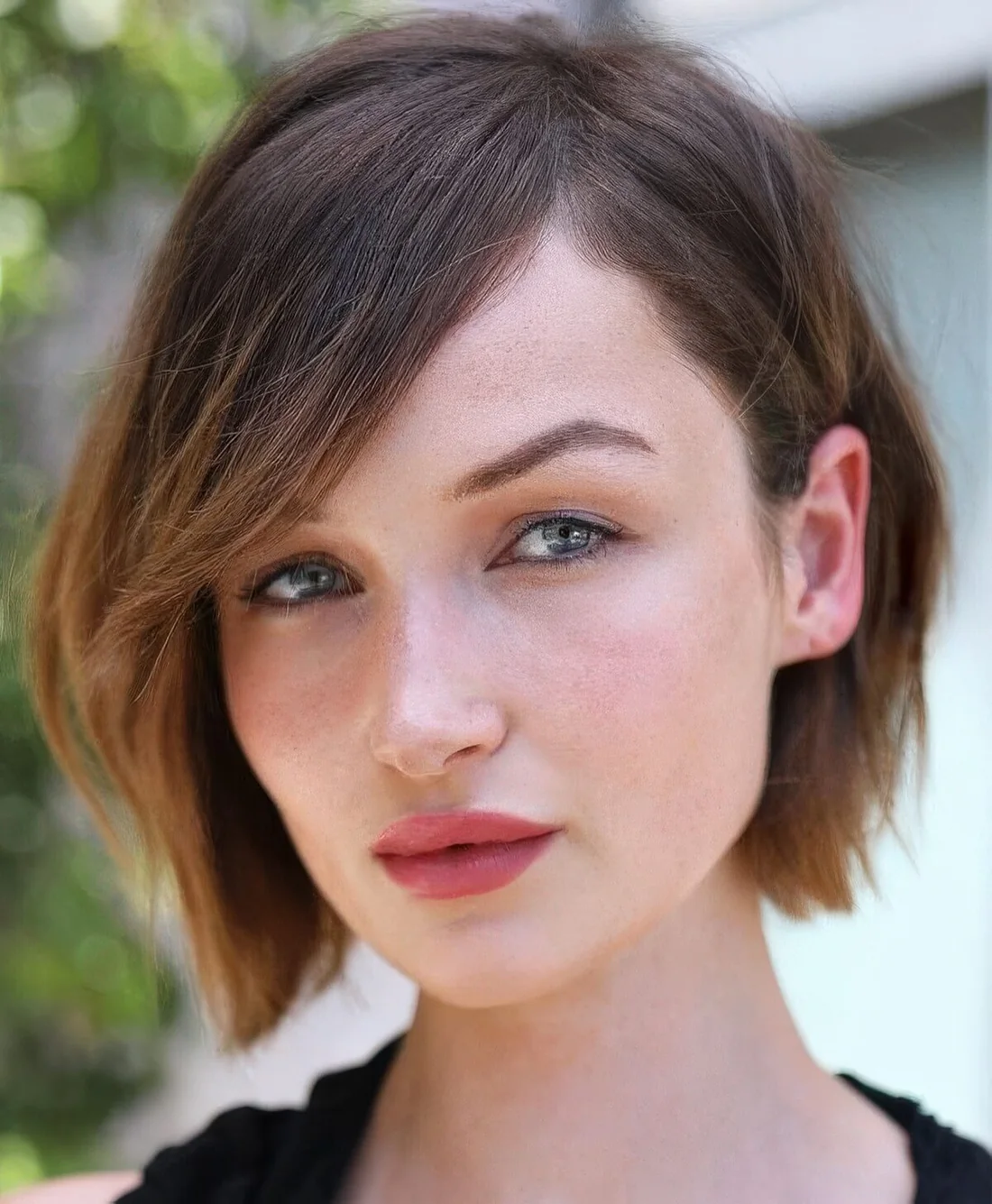 Chin-length brown bob with caramel ombre, side part and side bangs.